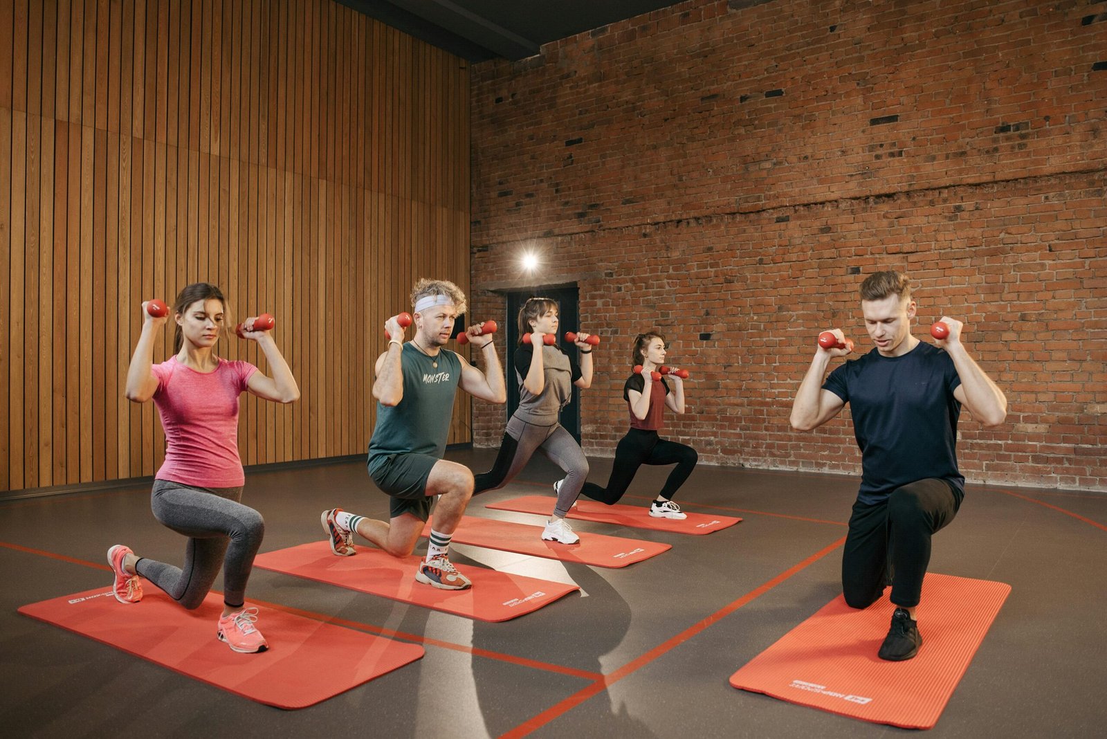 Home Indoor group workout session with dumbbells focusing on strength and fitness.